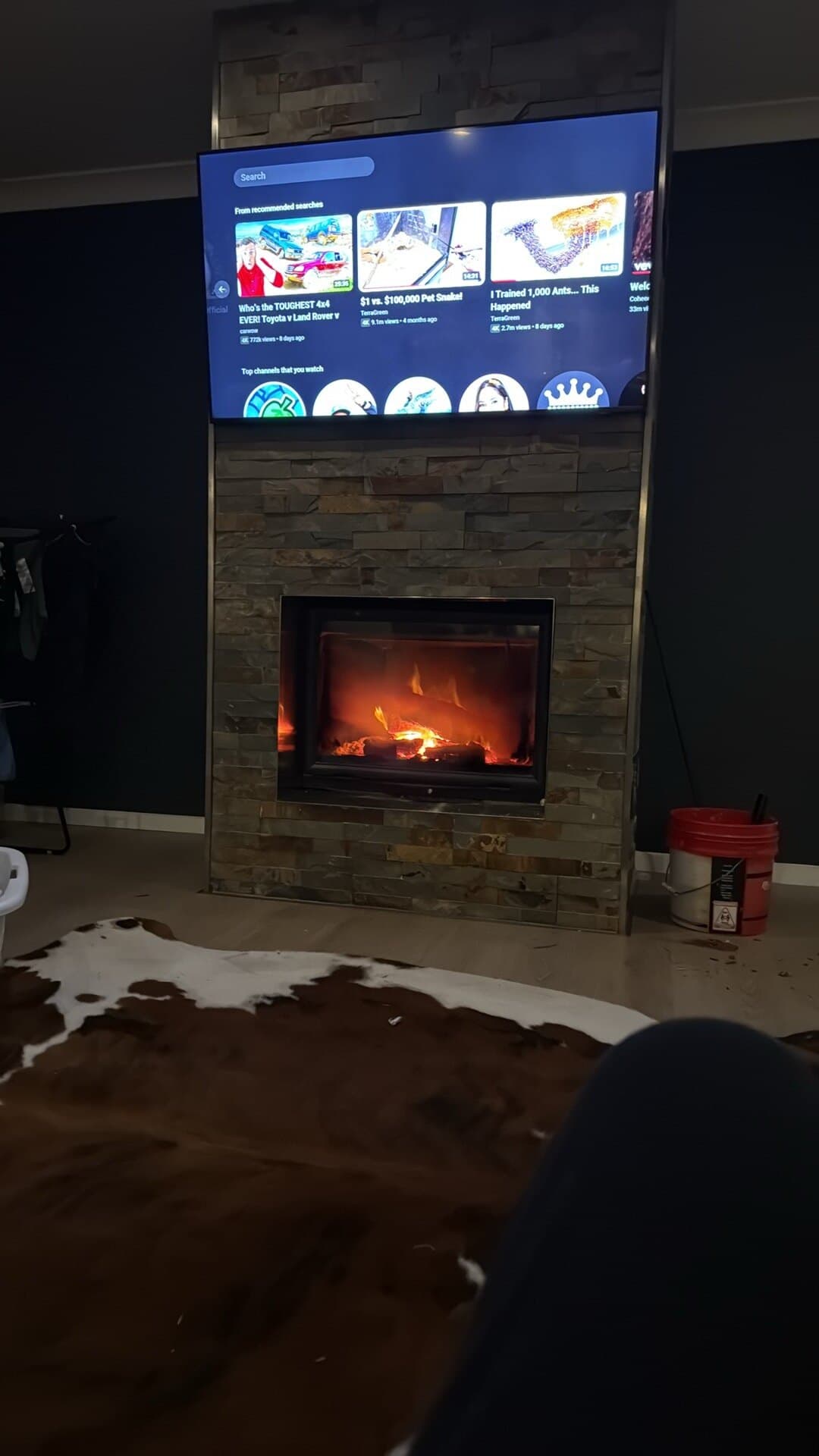 Indoor fireplace beneath a television
