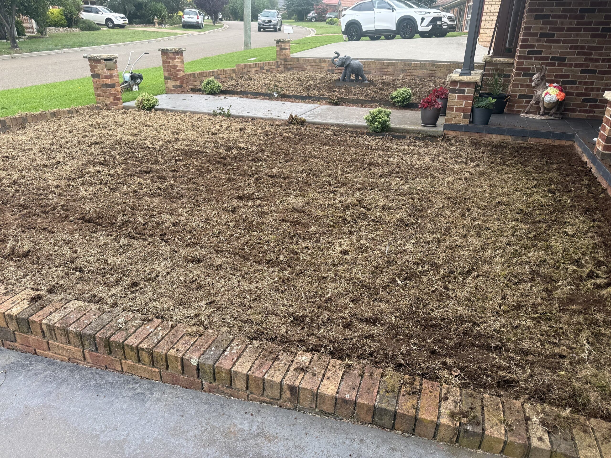 Prepared front soil area behind brick edging